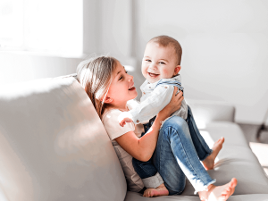 Healthy siblings on a sofa